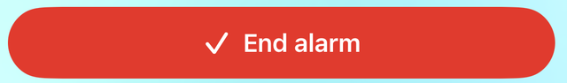 Il pulsante rosso “Termina allarme” con un segno di spunta.