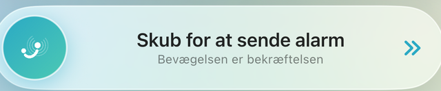 Knappen "Skub for at sende alarm" med underteksten "Bevægelsen er bekræftelsen".